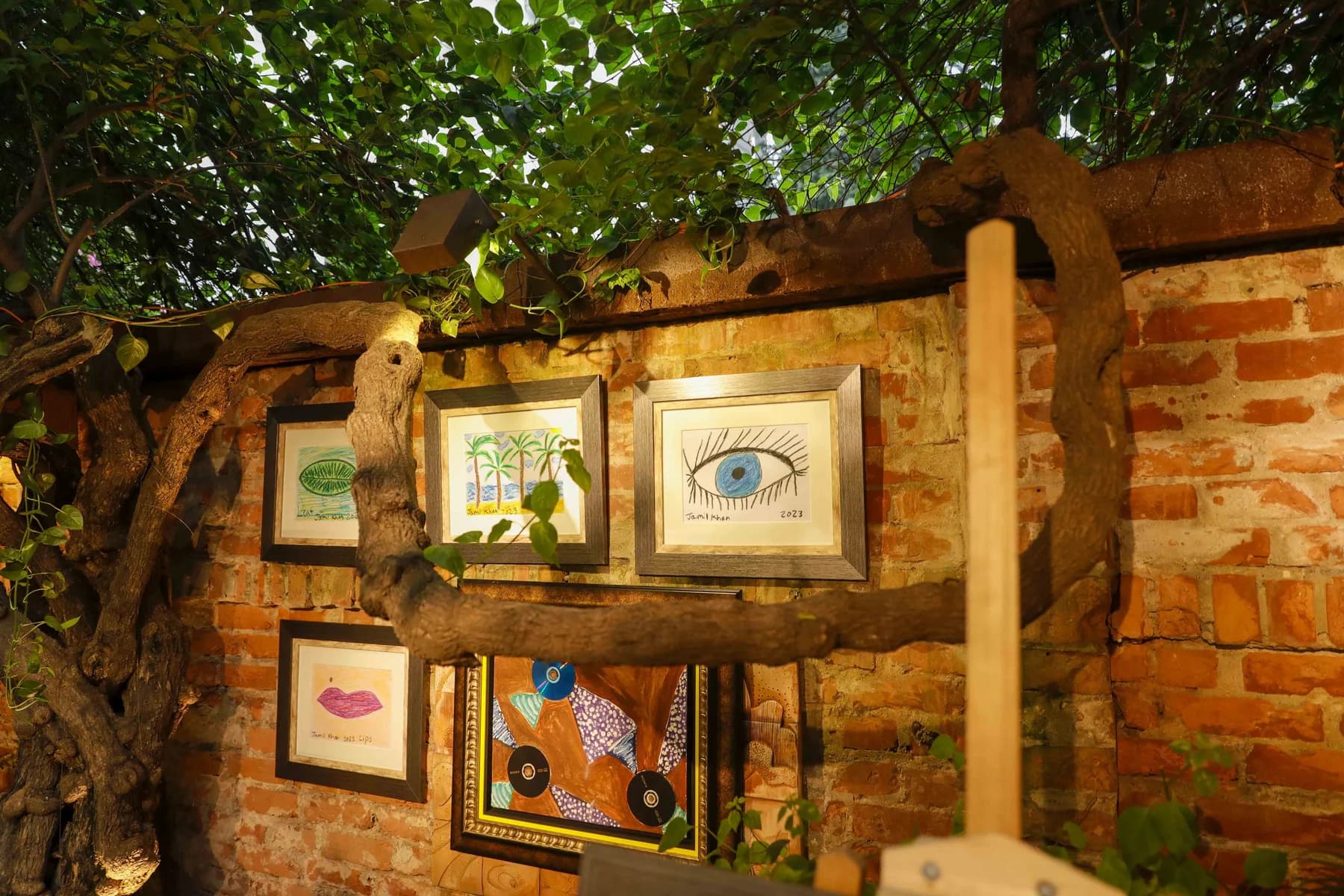 Small framed works on the garden wall — Inspiration, a solo exhibition by Jamil Khan at Gallery Cosmos