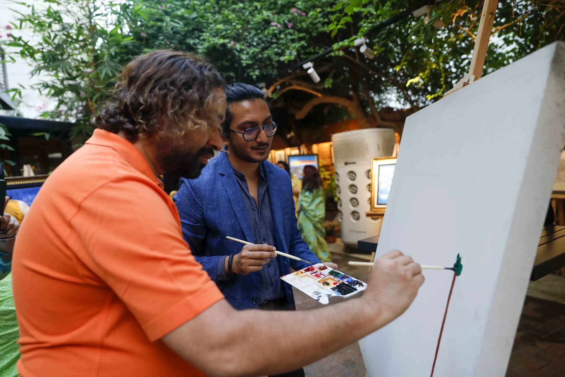 Painting at the easel during the evening — Inspiration, a solo exhibition by Jamil Khan at Gallery Cosmos