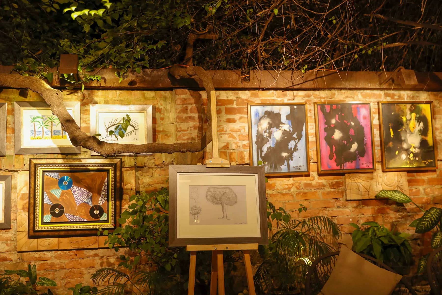 Framed works and easels along the wall — Inspiration, a solo exhibition by Jamil Khan at Gallery Cosmos