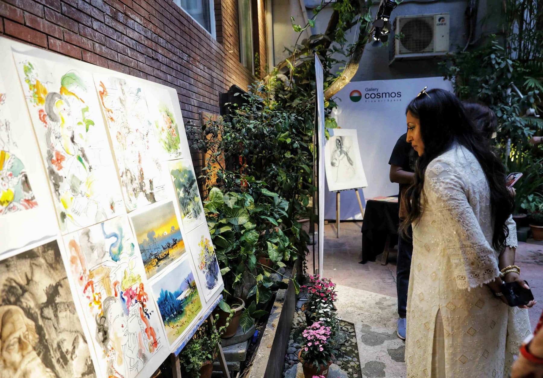 Watercolours made during the live drawing session displayed along the courtyard wall